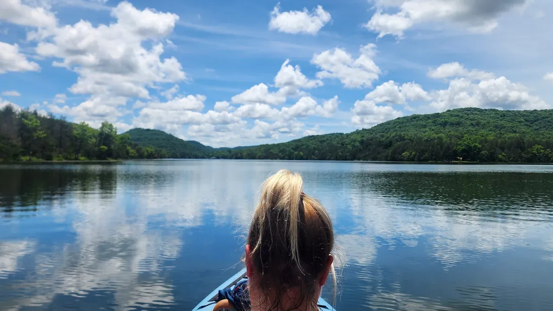 Brittany kayaking under a big sky full of clouds